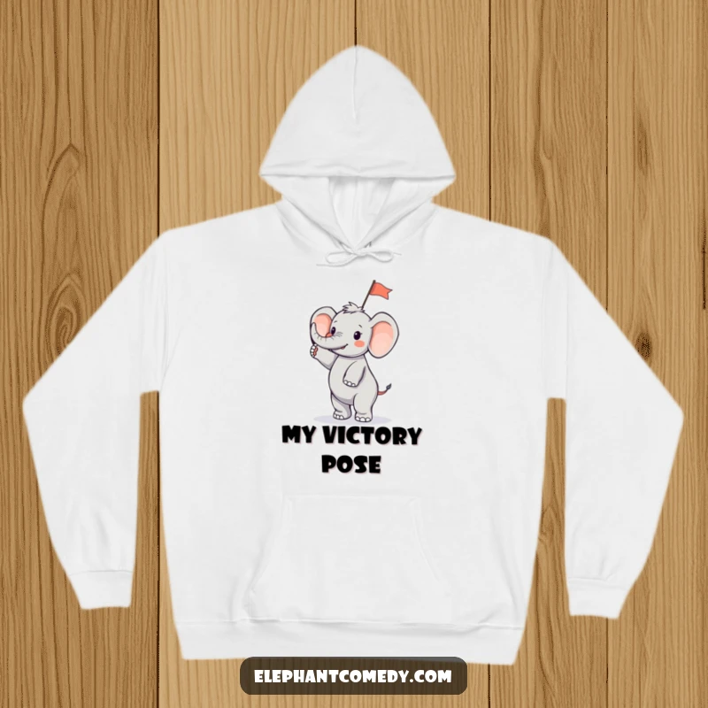 Funny tiny elephant hoodie showing a small elephant character standing on its hind legs and waving a small flag, exuding festive energy.